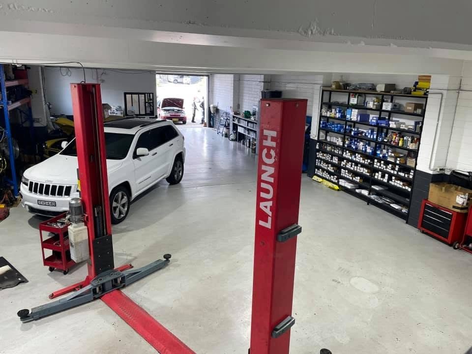Diesel ute raised on a hoist inside the Phillip Lim Automotive workshop